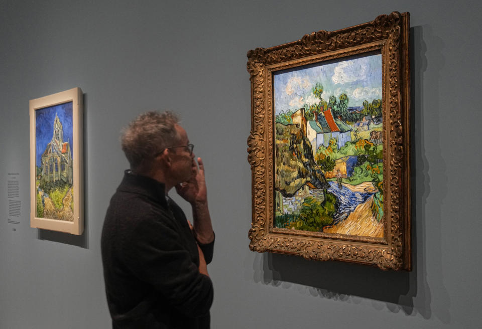 A man looks at Vincent van Gogh's oil on canvas painting, "House at Auvers-sur-Oise", 1890, during press day at the "Van Gogh in Auvers-sur-Oise: The Final Months" exhibition at the Musee d'Orsay in Paris, Friday, Sept. 29, 2023. The exhibition opens for the public from Oct. 3, 2023 to Feb. 4, 2024. The new Van Gogh exhibition concentrated on the two months before his death at age 37 on July 29, 1890, is both extraordinary and extraordinarily painful — because this brief period was one of the artist's most productive but was also his last. (AP Photo/Michel Euler)