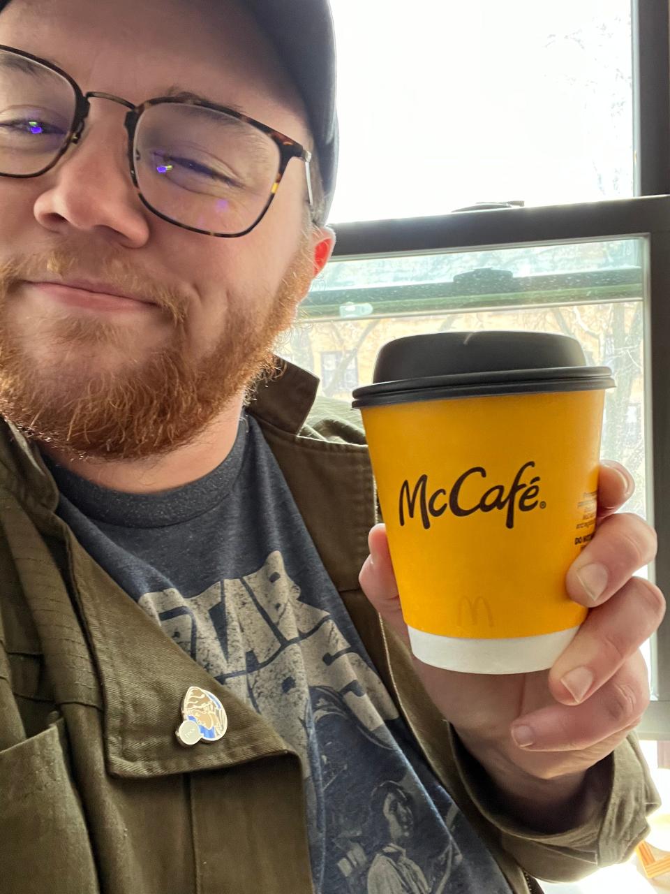dylan holding a cup of mcdonalds coffee
