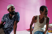 Riyazul Islam (L) whose name is excluded from the draft list of the National Register of Citizens (NRC), sits inside his house with his father in Dhubri district, in the northeastern state of Assam, India August 3, 2018. REUTERS/Adnan Abidi