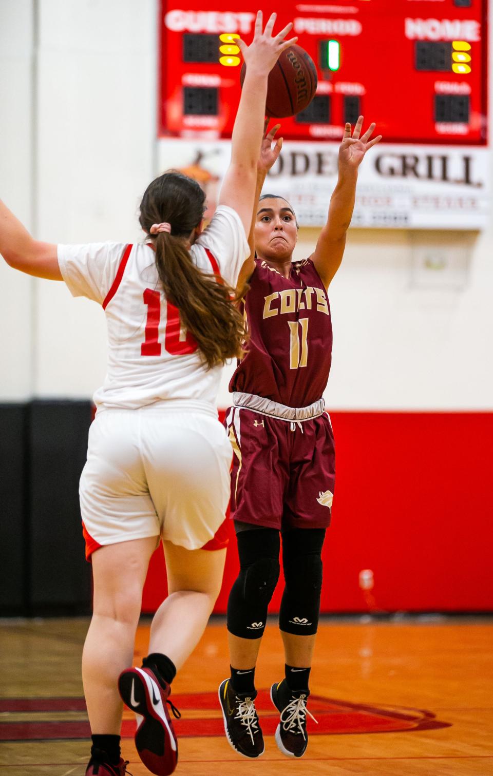 North Marion's Brianna Garcia shoots over Dunnellon's Paige Powell.