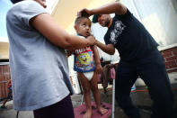 A boy, a member of a migrants caravan from Central America, gets his hair cut as he finishes the caravan journey through Mexico, prior to preparations for an asylum request in the U.S., in Tijuana, Baja California state, Mexico April 26, 2018. REUTERS/Edgard Garrido