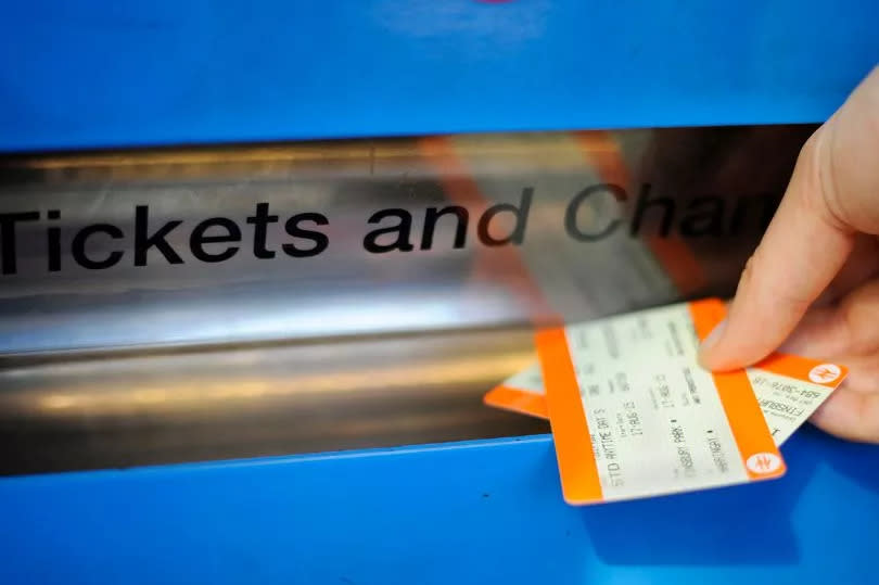 a person buying a train ticket