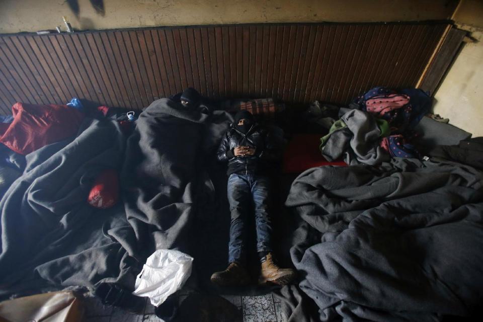 Migrants covered with blankets rest in an abandoned brick factory in the northern Serbian town of Subotica, near the border between Serbia and Hungary, Wednesday, Feb. 1, 2017. Thousands of migrants have been stranded in Serbia and looking for ways to cross illegally into the European Union. (AP Photo/Darko Vojinovic)