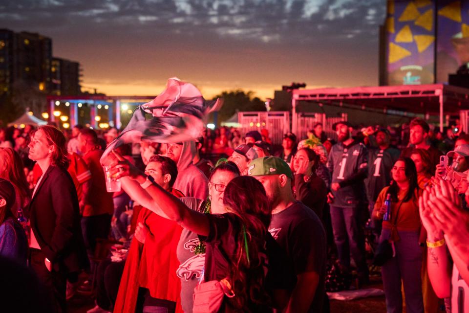 The sunsets as Rihanna fans dance and sing along with her Super Bowl LVII halftime show during the NFL's official Super Bowl LVII watch party at Margaret T. Hance Park in Phoenix, on Feb. 12, 2023.