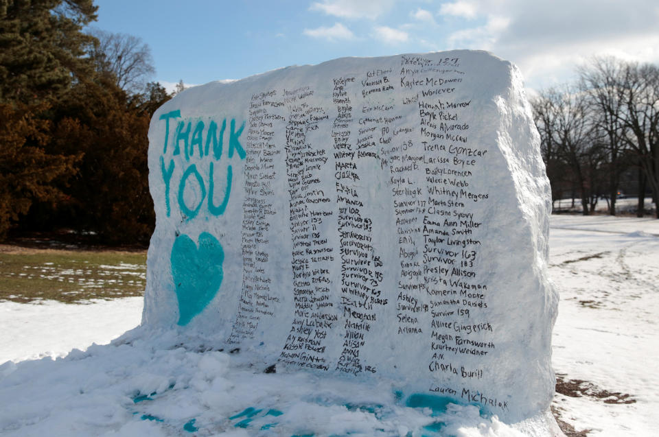 A boulder on the campus of Michigan State University is painted with the names of assault victims of Larry Nassar. (Photo: Rebecca Cook / Reuters)