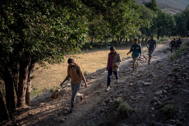 Migrants from Afghanistan walk along a village pathway to reach Tatvan city on July 17, 2021 in Tatvan, Turkey. (Photo: Chris McGrath via Getty Images)