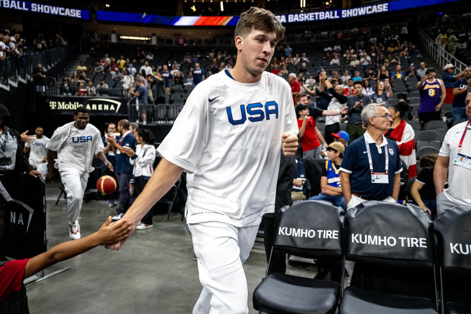 LAS VEGAS, NV - AUGUST 7, 2023: Team USA Austin Reaves gets a hand slap from a young fan before the game against Puerto Rico at T-Mobile Arena on August 7, 2023 in Las Vegas, Nevada. (Gina Ferazzi / Los Angeles Times via Getty Images)