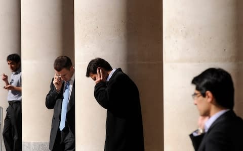 city workers making phone calls outside the London Stock Exchange in Paternoster Square in the City of London - Credit: &nbsp;TOBY MELVILLE/&nbsp;Reuters