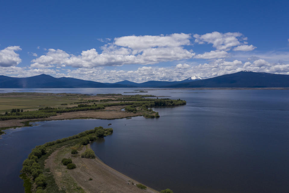 Clouds hover over the the Upper Klamath Lake on Thursday, June 10, 2021, near Klamath Falls, Ore. The farmers draw their water from the 96-square-mile lake, which is also home to suckerfish. (AP Photo/Nathan Howard)