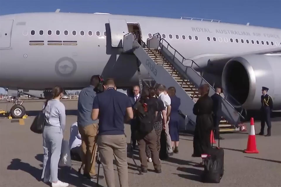 In this image from a video, Australian Prime Minister Anthony Albanese, center, speaks to reporters ahead of his departure in Perth, Australia Wednesday, March 8, 2023. Albanese said Wednesday he plans to meet with President Joe Biden in the United States following a trip to India this week, amid speculation the leaders will make an announcement about Australia's plans to build nuclear submarines. (Australia Pool via AP)