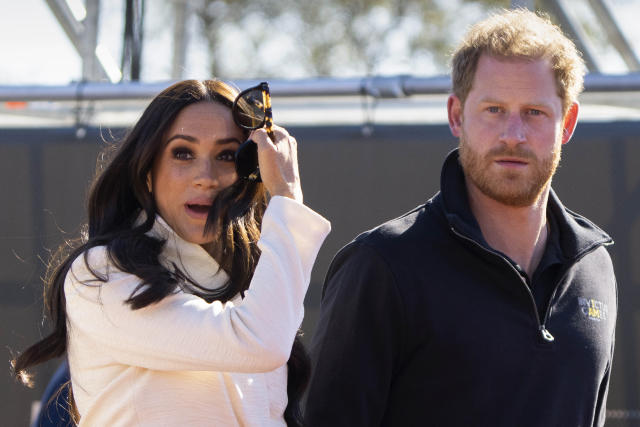 FILE - Prince Harry and Meghan Markle, Duke and Duchess of Sussex visit the track and field event at the Invictus Games in The Hague, Netherlands, Sunday, April 17, 2022. Prince Harry and his wife, Meghan, are expected to vent their grievances against the monarchy when Netflix releases the final episodes of a series about the couple&#x002019;s decision to step away from royal duties and make a new start in America. (AP Photo/Peter Dejong, File)