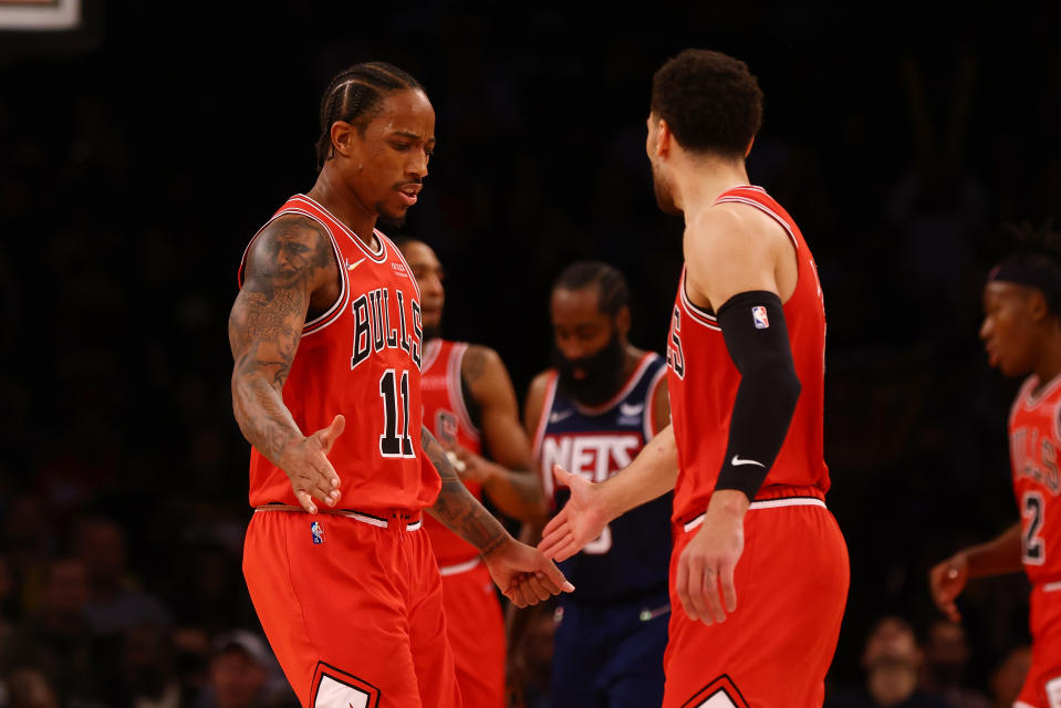 NEW YORK, NEW YORK - DECEMBER 04: DeMar DeRozan #11 of the Chicago Bulls celebrates with Zach LaVine #8 \H at Barclays Center on December 04, 2021 in New York City.  NOTE TO USER: User expressly acknowledges and agrees that, by downloading and or using this photograph, user is consenting to the terms and conditions of the Getty Images License Agreement. (Photo by Mike Stobe/Getty Images)