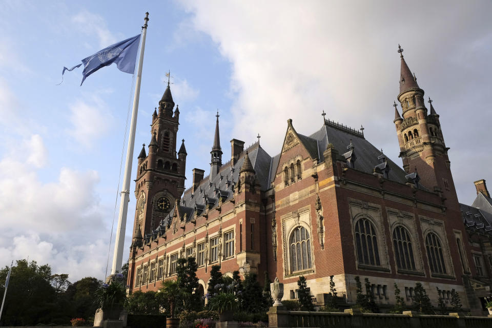 A United Nations flag flutters in the wind next to the International Court of Justice in the Hague, the Netherlands, Monday Aug. 27, 2018. Iran is going to the United Nations' highest court in a bid to have U.S. sanctions lifted. Iran filed the case with the International Court of Justice in July, claiming that sanctions the Trump administration imposed on May 8 breach a 1955 bilateral agreement known as the Treaty of Amity that regulates economic and consular ties between the two countries. (AP Photo/Mike Corder)