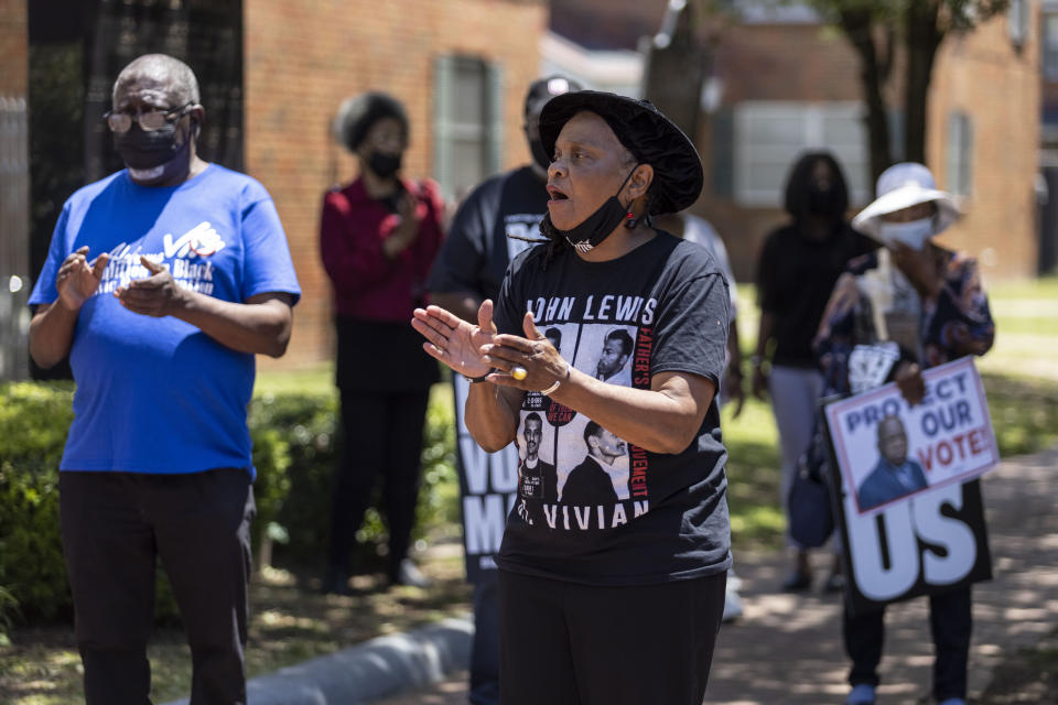 Faya Toure, center, cheers for voting rights at the John Lewis Advancement Act Day of Action, a voter education and engagement event, Saturday, May 8, 2021, in front of Brown Chapel A.M.E. Church in Selma, Ala. (AP Photo/Vasha Hunt)