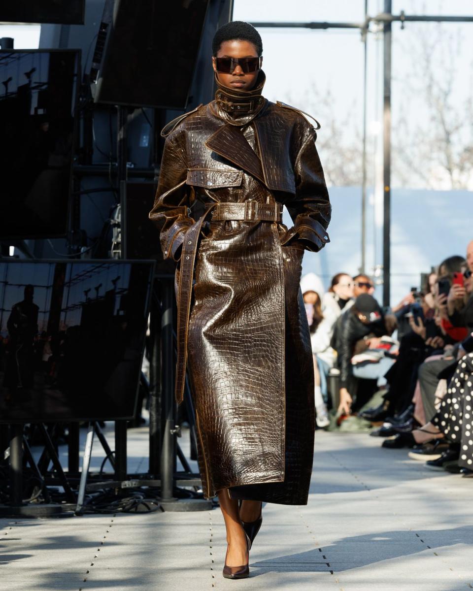 a person wearing a brown dress and sunglasses