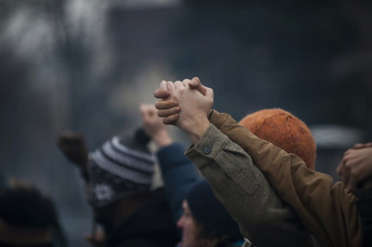 Demonstrators protest the fatal police shooting of Jamar Clark, 24, who they said was handcuffed when he was shot in the head on November 15, during Clark's funeral procession outside a Minneapolis police station on November 25, 2015