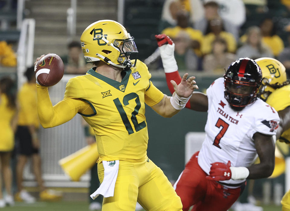 Baylor quarterback Blake Shapen (12) drops back to pass as Texas Tech linebacker Steve Linton (7) rushes in the first half of an NCAA college football game, Saturday, Oct. 7, 2023, in Waco, Texas. (Jerry Larson/Waco Tribune-Herald, via AP)