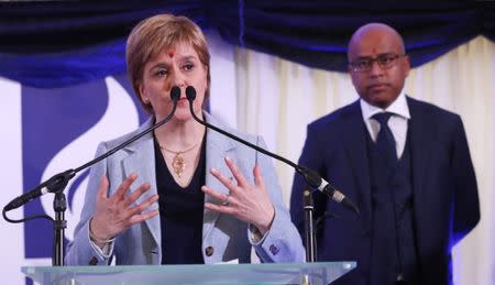 Scotland's First Minister Nicola Sturgeon speaks as Liberty executive chairman, Sanjeev Gupta watches at the recommissioning of the works by Liberty Steel Group at the Dalzell steel plant, in Motherwell, Scotland, Britain September 28 2016. REUTERS/Russell Cheyne