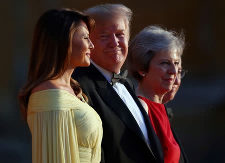 British Prime Minster Theresa May and her husband Philip stand together with U.S. President Donald Trump and First Lady Melania Trump at the entrance to Blenheim Palace, where they are attending a dinner with specially invited guests and business leaders, near Oxford, Britain, July 12, 2018. REUTERS/Hannah McKay