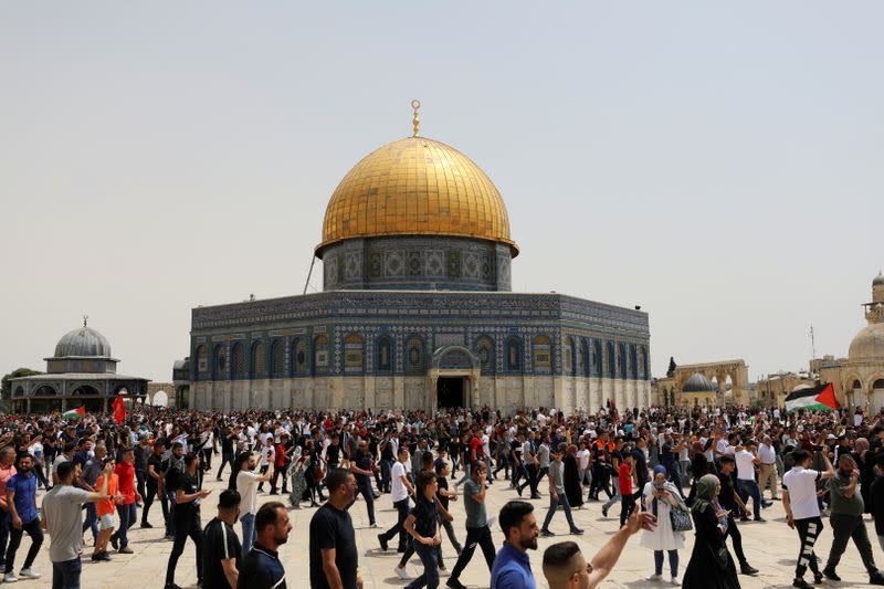 Palestinians walk at the compound that houses Al-Aqsa Mosque in Jerusalem's Old City