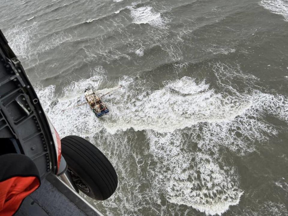 A Coast Guard aircrew arrives on the scene after reports of a disabled fishing boat off the coast of Duck, North Carolina, on the Outer Banks