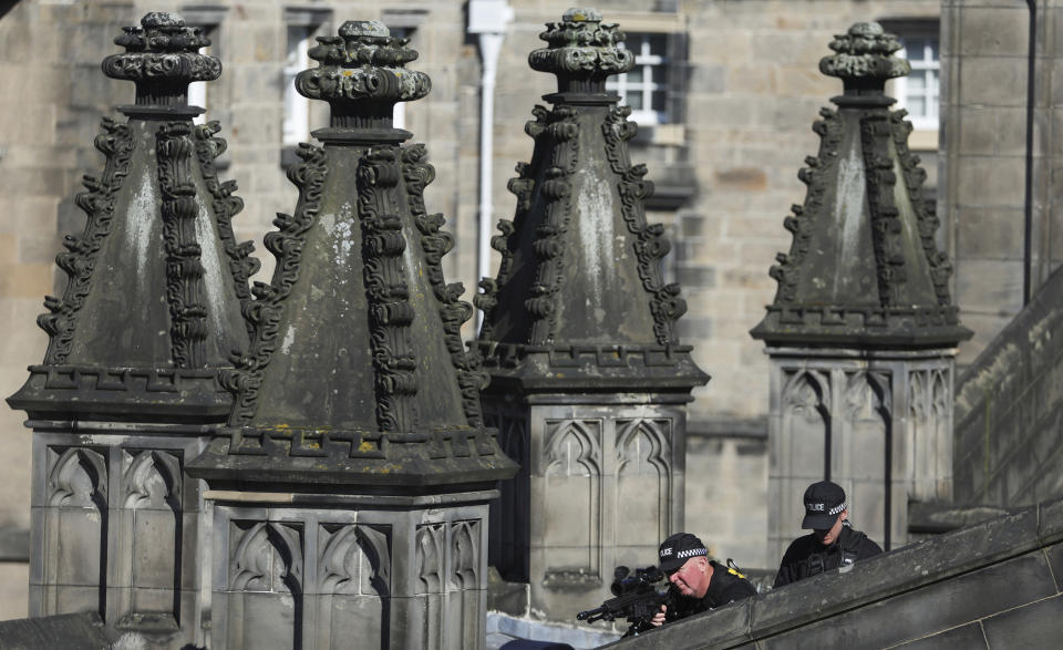 Police officers stand guard St. Giles Cathedral, in Edinburgh, Scotland, Tuesday, Sept. 13, 2022. King Charles III and Camilla, the Queen Consort, flew to Belfast from Edinburgh on Tuesday, the same day the queen’s coffin will be flown to London from Scotland. (Russell Cheyne/Pool Photo via AP)