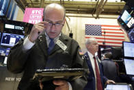 Trader Andrew Silverman, left, works on the floor of the New York Stock Exchange, Wednesday, March 29, 2017. Stocks are opening mostly lower on Wall Street led by declines in utilities and real estate companies. (AP Photo/Richard Drew)