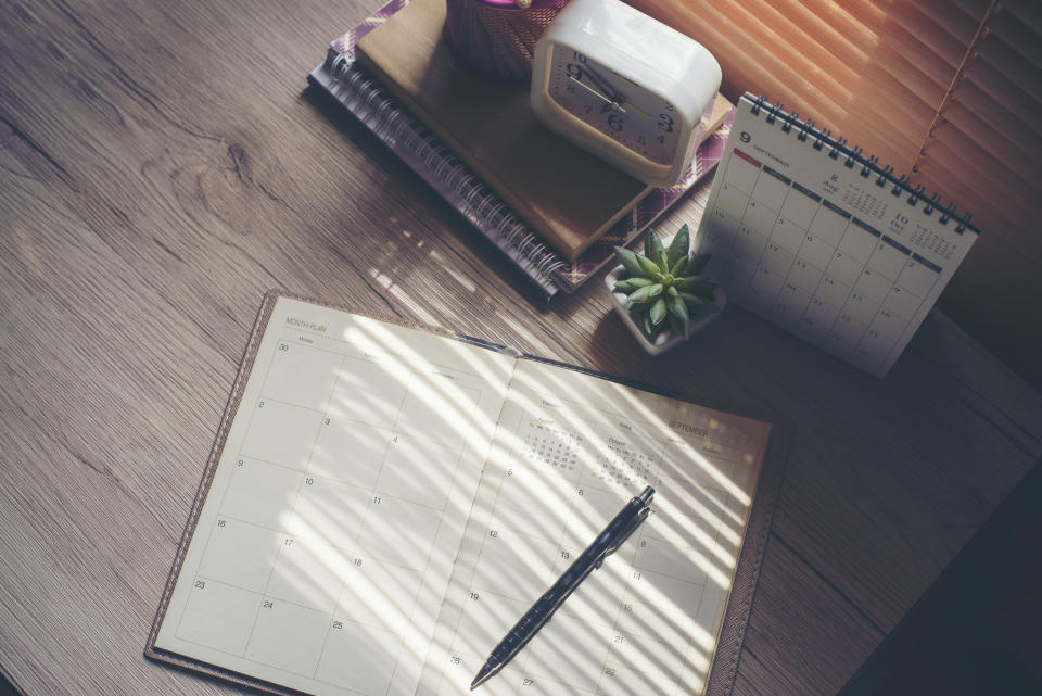 an agenda book and pen on a desk