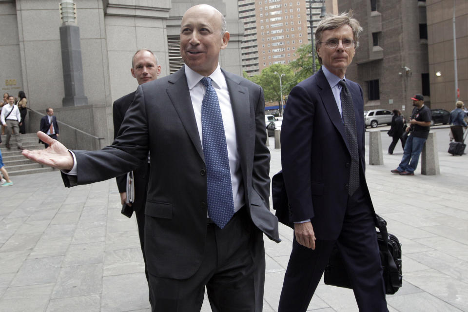 Goldman Sachs chairman and chief executive officer Lloyd Blankfein, left, leaves Federal court, Thursday, June 7, 2012 in New York. Blankfein testified at the New York insider trading trial of a former Goldman board member Rajat Gupta. (AP Photo/Mary Altaffer)