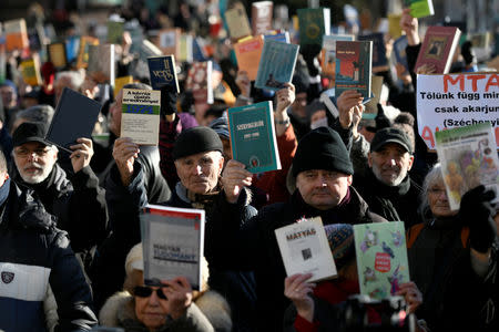 People raise science books outside the Hungarian Academy of Sciences to protest against government plans to weaken the institution in Budapest, Hungary, February 12, 2019. REUTERS/Tamas Kaszas