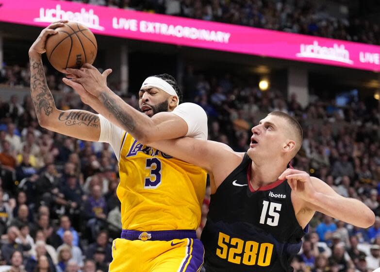 Los Angeles Lakers forward Anthony Davis (3) and Denver Nuggets center Nikola Jokic.