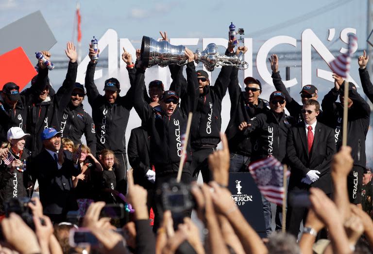 Oracle Team USA skipper James Spithill celebrates with the America's Cup trophy in San Francisco on September 25, 2013