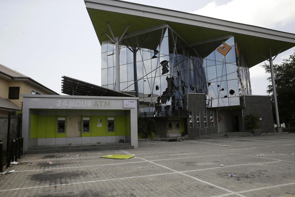 A damaged access bank in Lekki Lagos Friday, Oct. 23, 2020.Resentment lingered with the smell of charred tires Friday as Nigeria's streets were relatively calm after days of protests over police abuses, while authorities gave little acknowledgement to reports of the military killing at least 12 peaceful demonstrators earlier this week.(AP Photo/Sunday Alamba)