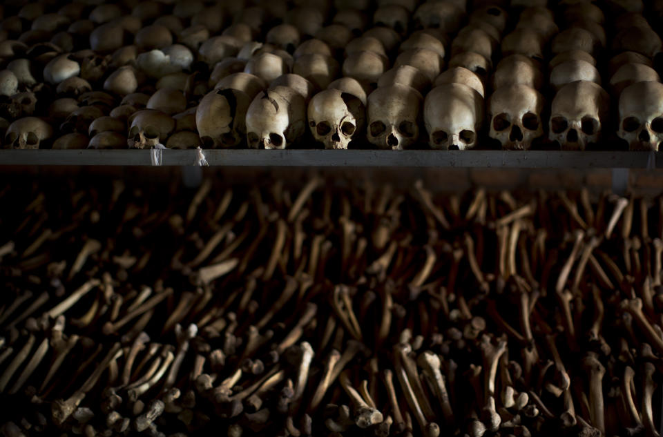 FILE - In this Friday, April 4, 2014 file photo, the skulls and bones of some of those who were slaughtered as they sought refuge inside the church are laid out as a memorial to the thousands who were killed in and around the Catholic church during the 1994 genocide in Ntarama, Rwanda. Félicien Kabuga, a former radio station owner, appeared Wednesday in a United Nations courtroom to face charges that he armed and incited militias that took part in Rwanda's 1994 genocide. It was the first time Kabuga had appeared before the U.N.'s International Residual Mechanism for Criminal Tribunals since he was transferred to The Hague following his arrest outside Paris in May. (AP Photo/Ben Curtis, File)