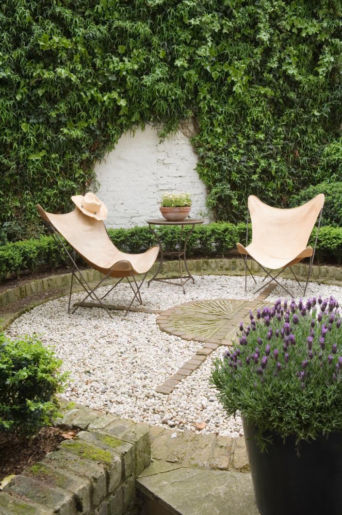 A few potted plants, chairs and a side table transform any backyard nook.