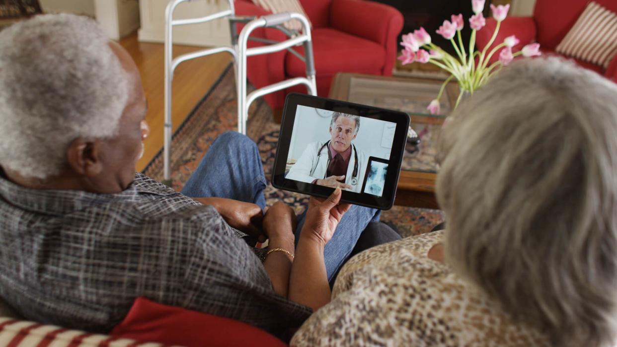 older couple talking with telemedicine doctor on tablet