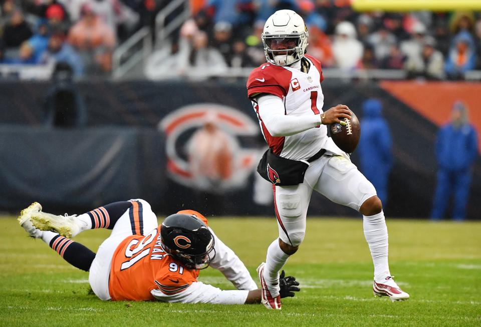 Cardinals quarterback Kyler Murray scrambles away from Bears defender Eddie Goldman during Sunday's game in Chicago.