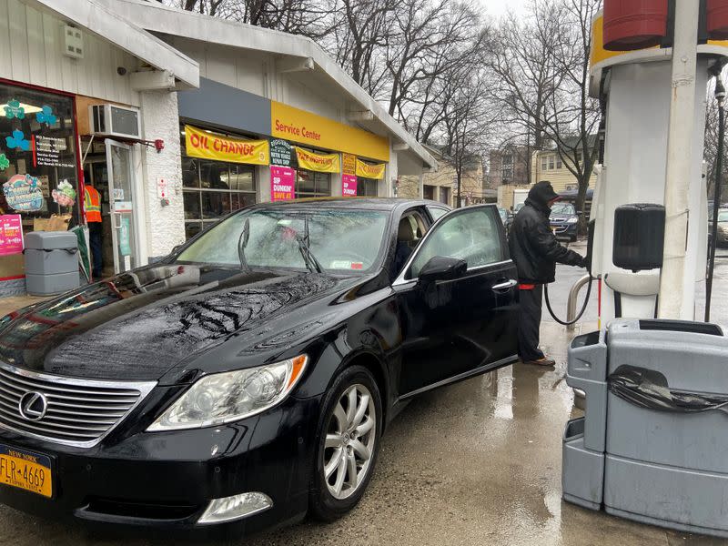 Julio Barrios attends to one of the few customers at a gas station in Scarsdale