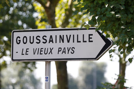 FILE PHOTO: A road sign indicates the way to Goussainville-Vieux Pays (old settlement), 20 kms (12 miles) north of Paris, August 21, 2013. REUTERS/Charles Platiau/File Photo