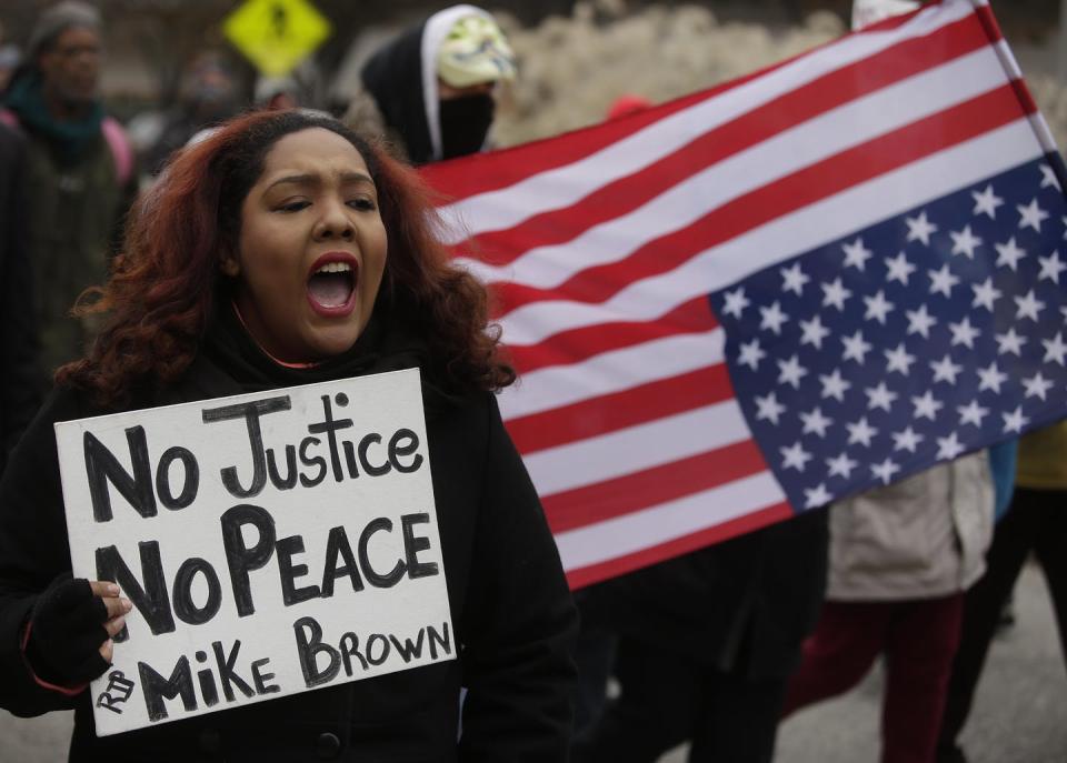 <span class="caption">Protesters demonstrated across the country after Michael Brown’s death in 2014.</span> <span class="attribution"><a class="link " href="https://www.gettyimages.com/detail/news-photo/demonstrators-protest-the-shooting-death-of-michael-brown-news-photo/459618934?adppopup=true" rel="nofollow noopener" target="_blank" data-ylk="slk:Joshua Lott/Getty Images;elm:context_link;itc:0;sec:content-canvas">Joshua Lott/Getty Images</a></span>