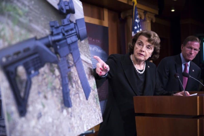 Former U.S. Sen. Diane Feinstein, D-Calif., points to a semiautomatic rifle equipped with a bump stock similar to ones used to murder 58 and injure nearly 500 more during the Route 51 Harvest Festival in Las Vegas in 2017. Photo by Shawn Thew/EPA-EFE
