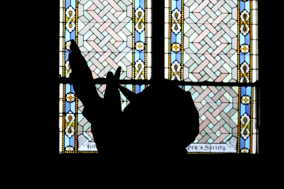 A man prays during a prayer service for Buffalo Bills' Damar Hamlin at Crossroads Uptown Church, Tuesday, Jan. 3, 2023, in Cincinnati. The family of Damar Hamlin expressed gratitude for the outpouring of support shown toward the Buffalo Bills safety who suffered cardiac arrest after making a tackle while asking everyone to keep the hospitalized player in their prayers on Tuesday. (AP Photo/Darron Cummings)