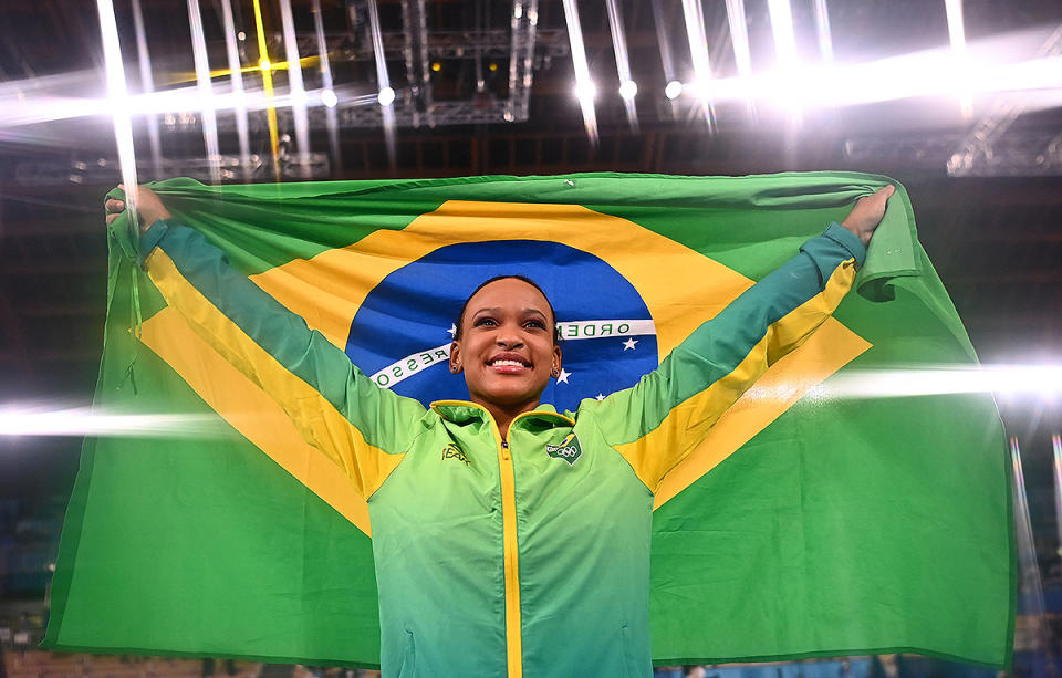<p>Brazil's Rebeca Andrade raises her flag with pride after winning gold in the vault event of the artistic gymnastics women's vault final at the Ariake Gymnastics Centre on August 1.</p>