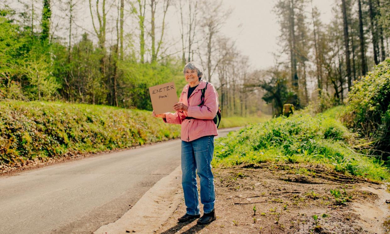 <span>Hilary Bradt holds out a polite sign on a road near Colyton, Devon.</span><span>Photograph: Peter Flude</span>