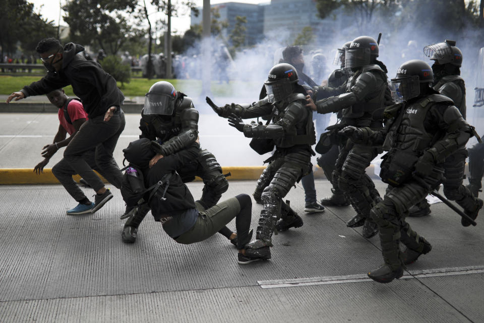 Police detain an anti-government demonstrator during a nationwide strike in Bogota, Colombia, Thursday, Nov. 21, 2019. Colombia's main union groups and student activists called for a strike to protest the economic policies of Colombian President Ivan Duque government and a long list of grievances. (AP Photo/Ivan Valencia)