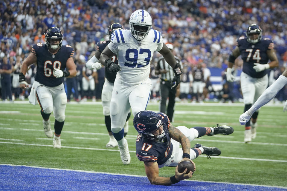 Chicago Bears quarterback Tyson Bagent (17) scores a touchdown in front of Indianapolis Colts defensive tackle Eric Johnson (93) during the first half of an NFL preseason football game in Indianapolis, Saturday, Aug. 19, 2023. (AP Photo/Darron Cummings)