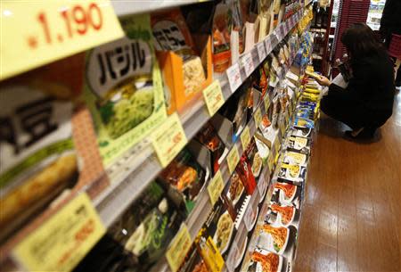 A customer looks at food products at a supermarket in Tokyo January 30, 2014. REUTERS/Yuya Shino