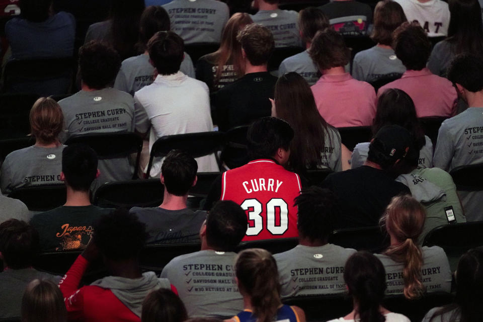 Students and fans watch as Golden State Warriors Stephen Curry gets his number and jersey retired at Davidson College on Wednesday, Aug. 31, 2022, in Davidson, N.C. Curry was also inducted into the school's Hall of Fame and had his graduation ceremony. (AP Photo/Chris Carlson)