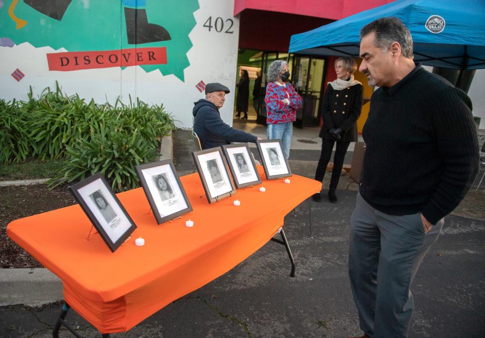 Marcus Omlin looks at a display of photos of children, Sokihm An, Thuy Tran, Rathanar Or, Ouem Lim and Ram Chun, who were killed in the Cleveland Elementary School shooting on Jan. 17, 1989,  during a remembrance ceremony at the Children's Museum of Stockton in downtown Stockton on Tuesday, Jan. 17, 2023. The museum was founded by Janet Geng, as teacher who was wounded in the shooting.