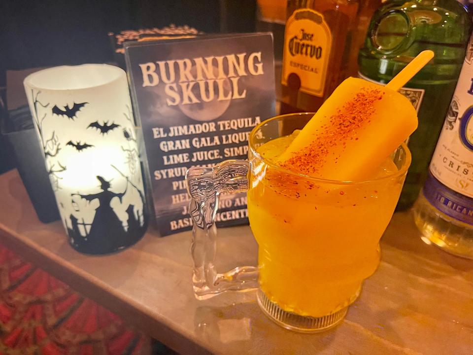 burning skull cocktail with popsicle on top at halloween horror nights